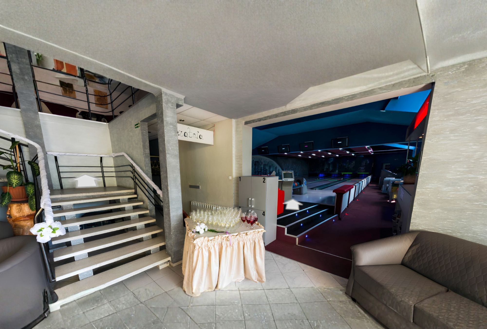 Nowoczesne wnętrze restauracji z schodami, stołem z lampkami szampana i eleganckim otwartym salą.