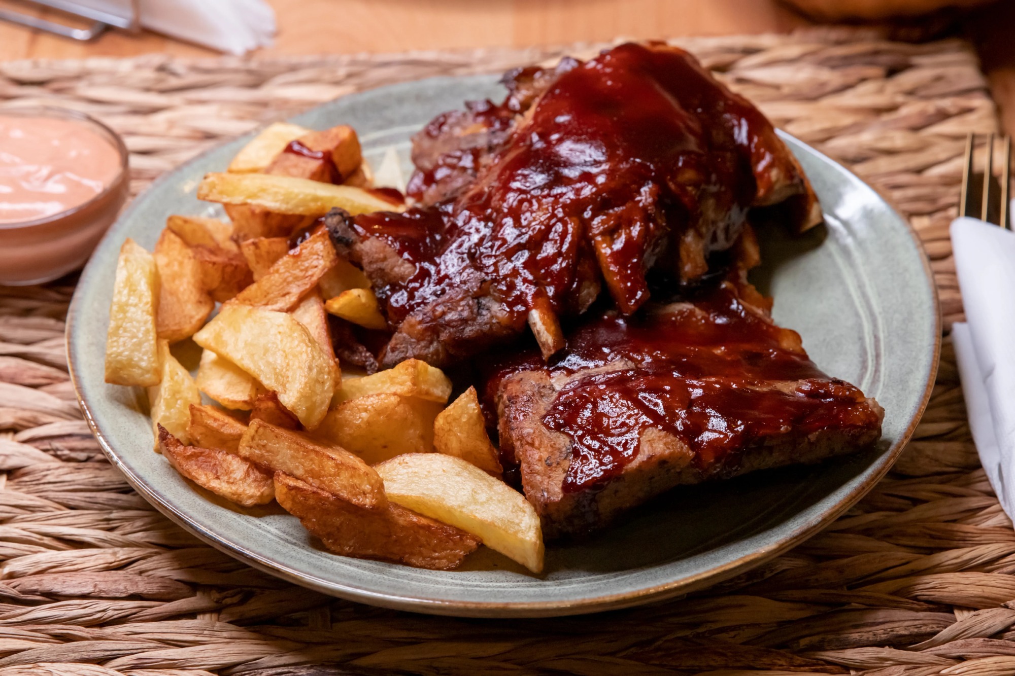 Coaste de porc la cuptor cu cartofi wedges și sos rosa